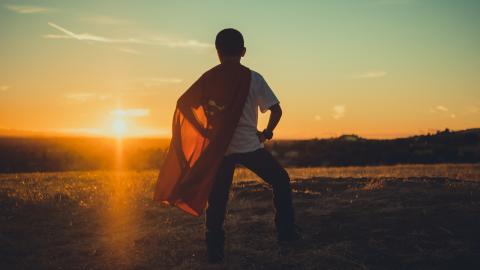 Boy facing the sun wearing a superman cape by Matt Vasquez. Used by Permission.