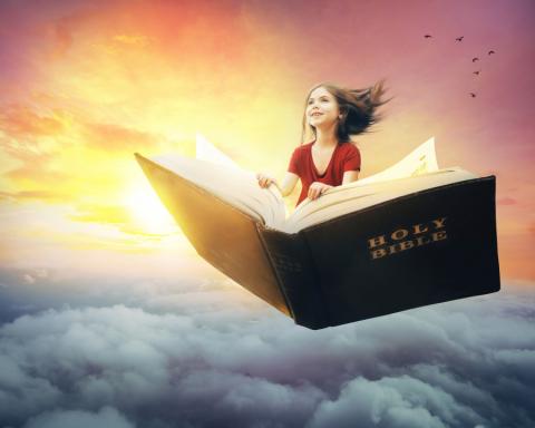 Girl riding through the air on a Bible  | Kevin Carden | lightstock.com | Used by Permission.